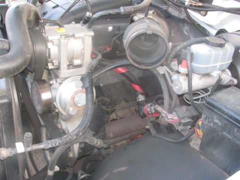 1996 Ford C-350 (Centurion Conversions) - Close-up view of an engine bay, showing various mechanical and electrical components.