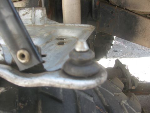 1996 Ford C-350 (Centurion Conversions) - Close-up of a vehicle's suspension system, focusing on a ball joint and surrounding components.