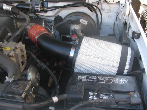 1996 Ford C-350 (Centurion Conversions) - Aftermarket air intake system installed in the engine bay of a vehicle.