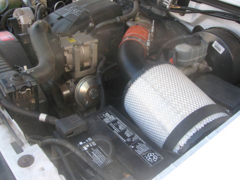 1996 Ford C-350 (Centurion Conversions) - Aftermarket open air intake system installed in a vehicle's engine bay.