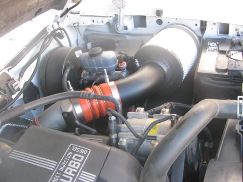 1996 Ford C-350 (Centurion Conversions) - Close-up of an engine bay, focusing on the air intake system and engine components.