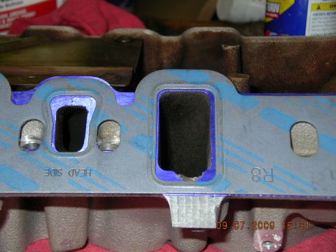 1996 Ford Bronco - Close-up of an engine intake manifold gasket, showing the port openings and bolt holes.