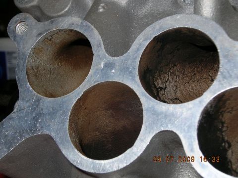 1996 Ford Bronco - Close-up of an intake manifold, showing internal wear and carbon deposits.
