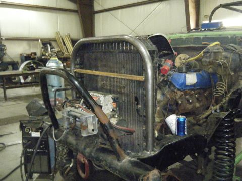 1978 Ford Bronco - Front view of a heavily modified vehicle, showing custom roll cage, exposed engine, and radiator.