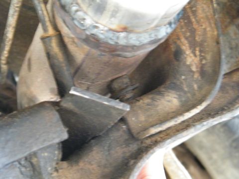 1982 Ford Bronco - Undercarriage detail showing welded components and a metal bracket on a vehicle.