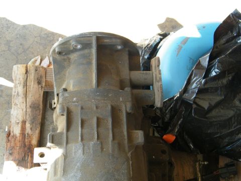 1982 Ford Bronco - A close-up view of a vehicle transmission component, resting on wooden supports.