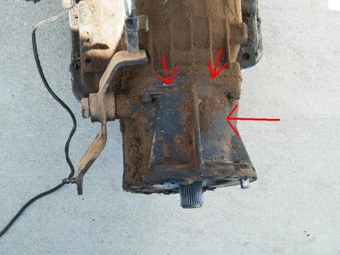 1982 Ford Bronco - Close-up view of a transmission housing, with red arrows highlighting certain sections for identification.