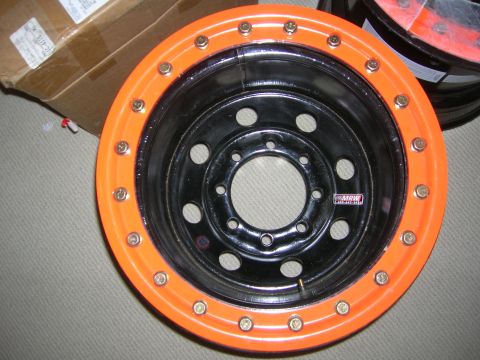 1975 Ford F-250 - A close-up view of an orange and black wheel with a MRW sticker visible on the hub.