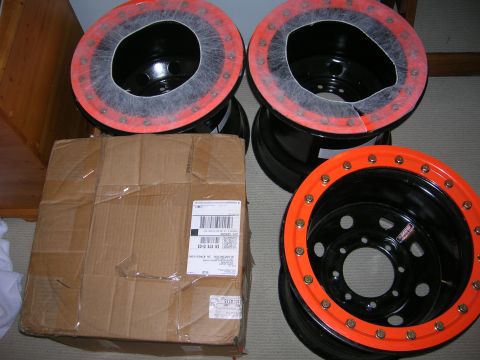 1975 Ford F-250 - Four new off-road wheels are shown next to a shipping box.