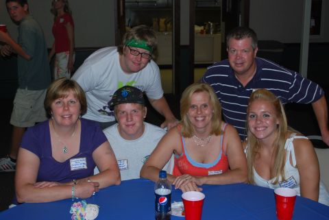 1996 Ford Bronco - A group of people gathered around a table, possibly at a reunion or event, smiling for the camera.