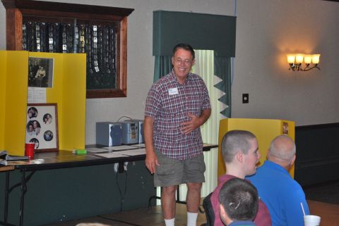 1996 Ford Bronco - A man presents at an event with family photos and memorabilia on display.