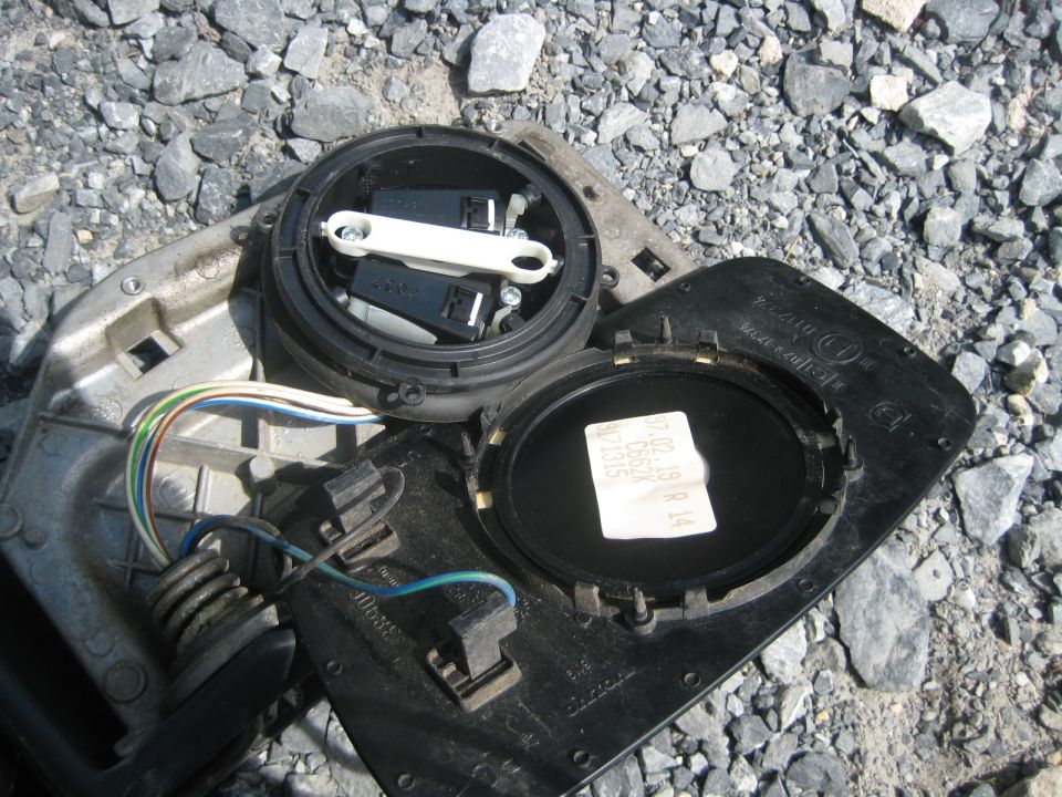Disassembled side mirror assembly with wiring and label
