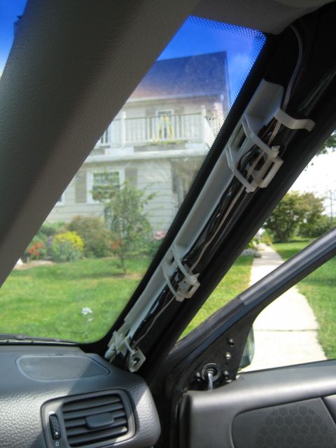 1993 Ford Probe - Interior view of a car's windshield pillar showing wiring secured with zip ties. The Supermotors.net logo is visible in the lower right cor…