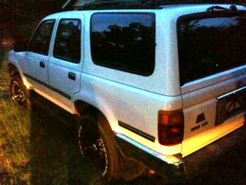 1993 Toyota 4Runner - Rear view of a white 1993 Toyota 4Runner parked on grass.