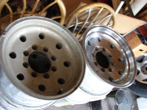 1985 Ford F-150 - Two aluminum truck wheels are shown, one in the foreground and another to the right.