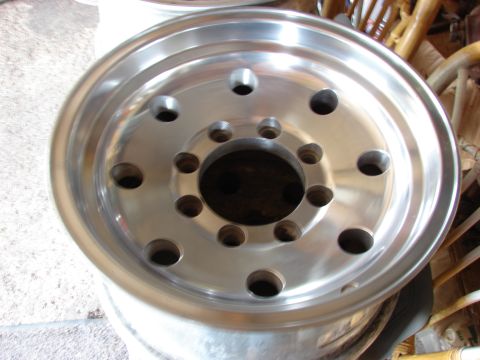 1985 Ford F-150 - A polished aluminum wheel with a multi-lug pattern is shown in detail.