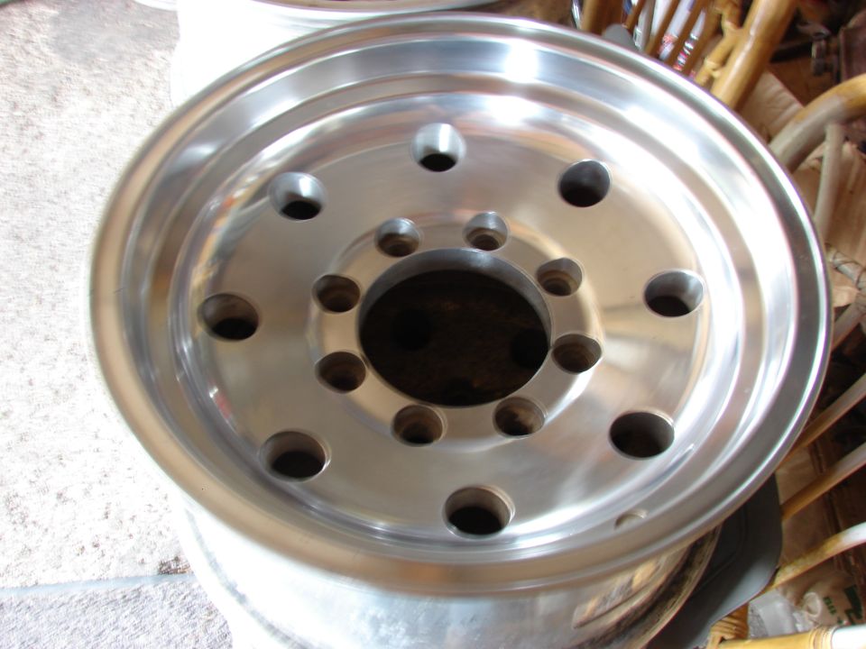 Close-up of a shiny aluminum wheel with many lug nut holes