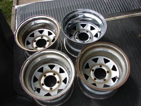 1985 Ford F-150 - Set of four steel wheels, likely for a truck or SUV, shown in a truck bed.