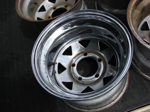1985 Ford F-150 - Several chrome wheels are shown, with one in the foreground and others partially visible in the background.