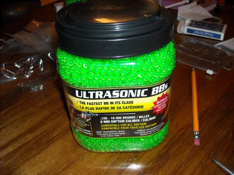 1979 Ford F-150 - Jar of green Ultrasonic BBs, 10,000 rounds, 6mm softair caliber, is shown on a table.