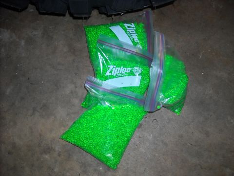 1979 Ford F-150 - Several Ziploc bags filled with bright green beads are scattered on a concrete surface.