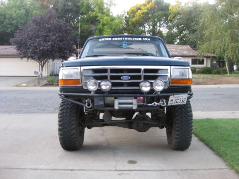 1995 Ford Bronco - This 1995 Ford Bronco features a custom front bumper and winch, ready for off-road adventures.