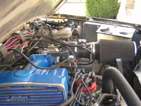 1993 Ford F-150 - Close-up of a vehicle's engine bay, aftermarket parts like blue valve covers and an air intake system.