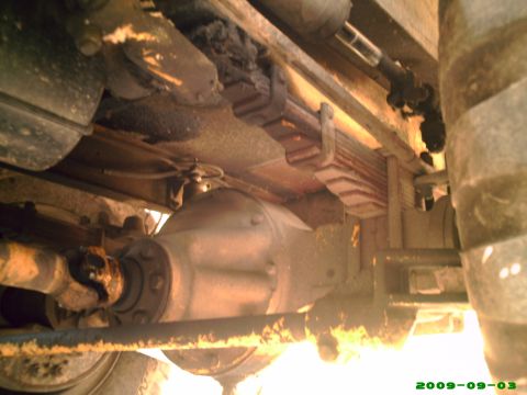 1978 Ford Bronco - This photo shows the undercarriage of a vehicle, focusing on the rear axle and suspension components.