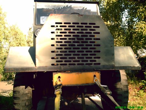 1978 Ford Bronco - This heavy-duty vehicle features a prominent metal grille and a yellow tow hitch, with large tires visible.