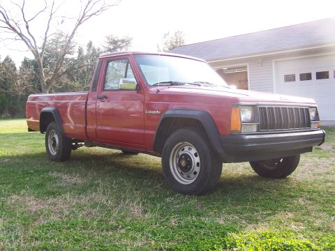 1991 Jeep Comanche - Red 1991 Jeep Comanche pickup truck with a single cab and short bed.