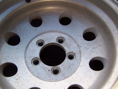 1991 Jeep Comanche - Close-up view of an aluminum wheel, showing its lug nut holes and central hub opening.