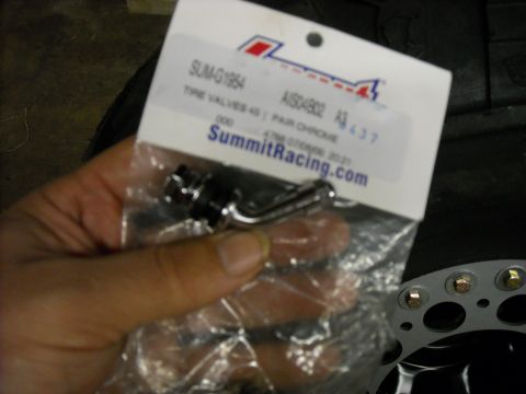 1979 Ford F-150 - A pair of chrome tire valves, part number SUM-G1954, are held in packaging from Summit Racing.