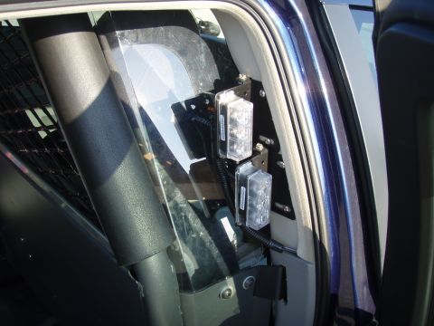 2006 Dodge Charger - Interior view of a police car showing mounted LED lights on the B-pillar.