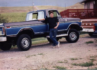 1979 Ford F-350 - A man poses with a two-tone blue and brown 1979 Ford F-350 pickup truck, which appears to be a 1-ton model.
