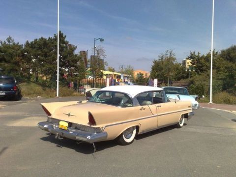 1991 Ford Crown Victoria - Rear view of a 1956 Lincoln Premiere, parked next to another vehicle.