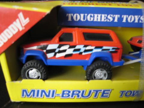 1986 Ford Bronco - This toy Bronco, likely a Buddy L Mini-Brute, is displayed in its original packaging with "Toughest Toys" printed on the box.