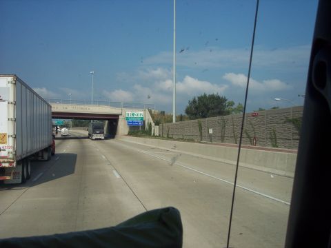 1960 Ford Falcon - Driving on the highway, passing an overpass with state signage and other vehicles.