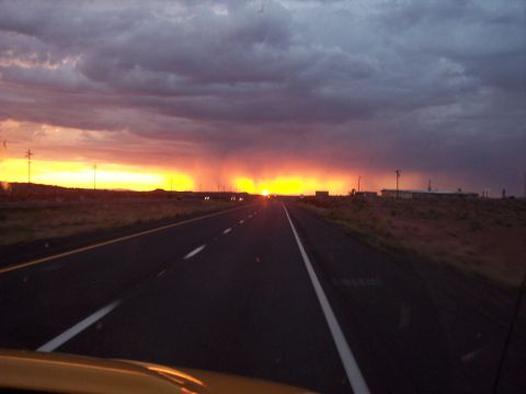 1960 Ford Falcon - The road ahead leads into a vibrant sunset, with rain falling in the distance.