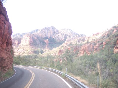 1960 Ford Falcon - Scenic drive through a mountainous region with red rock formations.