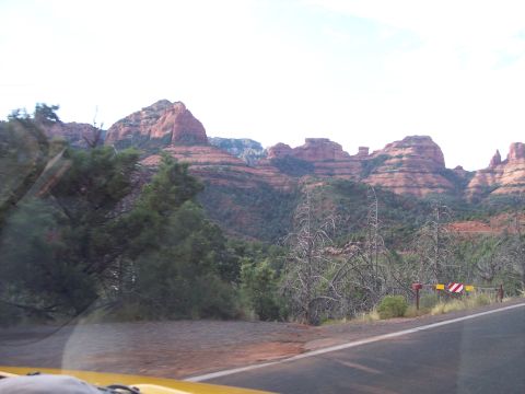 1960 Ford Falcon - View from a car traveling on a road through a landscape of red rock formations.