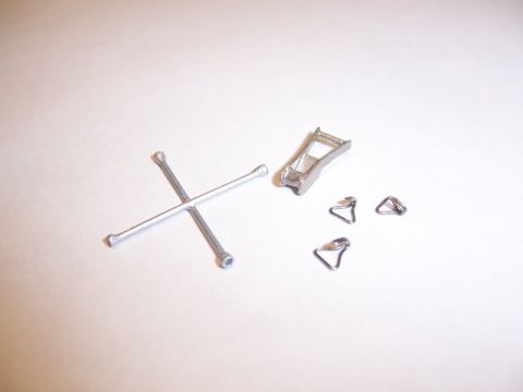 1986 Ford Bronco - A lug wrench and several jack parts are laid out on a white surface.