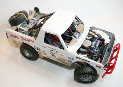 1986 Ford Bronco - This detailed model truck features a roll cage, spare tire, and a heavily modified engine bay.