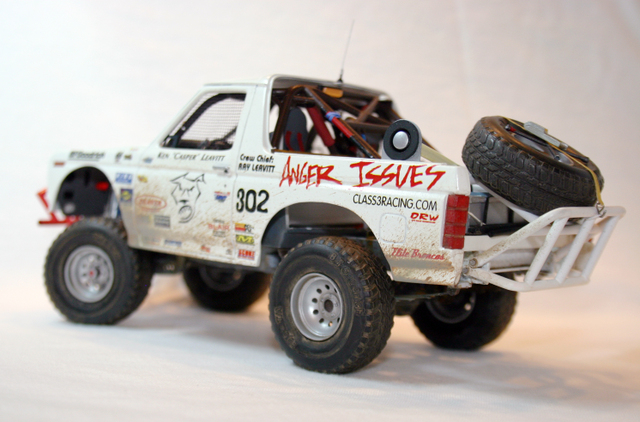 White off-road truck with 'Anger Issues' and 'CLASS3RACING.COM' text, spare tire on rear