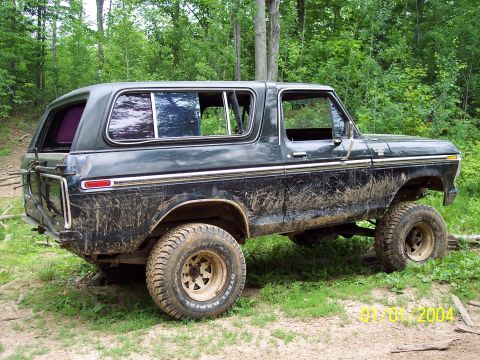 1979 Ford Bronco - This lifted Ford Bronco is covered in mud, indicating it has been used off-road.