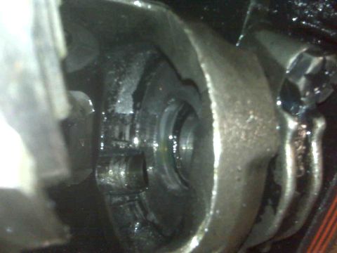 1995 Ford Bronco - A greasy differential housing is shown in detail, revealing internal gears and fasteners.