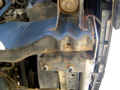 1996 Ford Bronco - Underside view of vehicle frame and radiator support structure.