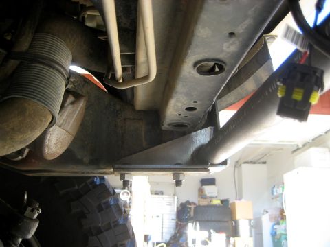 1996 Ford Bronco - Close-up view of the undercarriage of a vehicle, showing frame and suspension components.