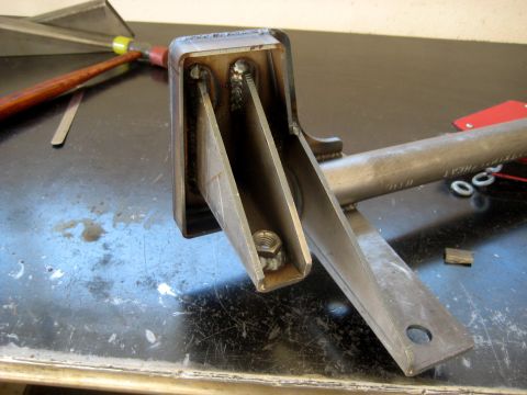 1996 Ford Bronco - Close-up view of a custom-fabricated metal component, likely a part for a vehicle, showing welding and fastening hardware.
