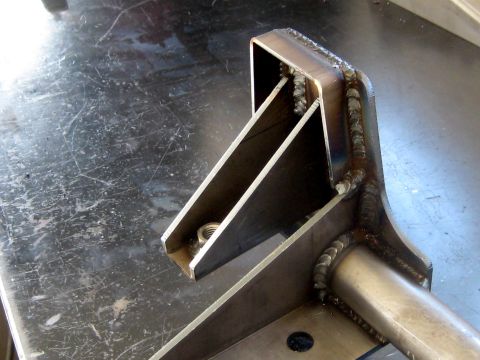 1996 Ford Bronco - A metal bracket, likely a custom fabrication, is shown with visible welds and a nut secured within its structure.