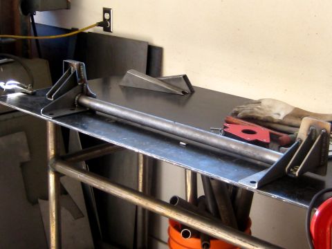 1996 Ford Bronco - A metal fabrication jig is set up on a workbench, ready for use in a workshop environment.